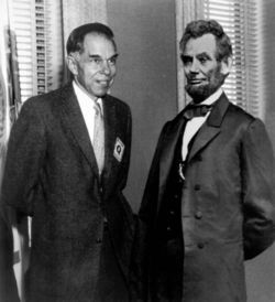 Seaborg posing with statue of Lincoln 